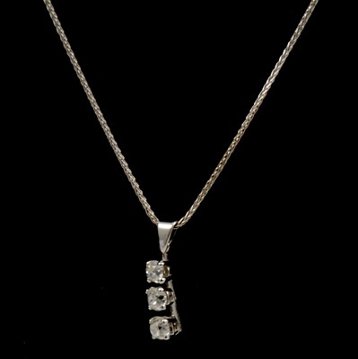 Lot 261 - A diamond three stone pendant on chain.