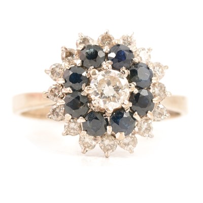 Lot 25 - A 1970's sapphire and diamond reverse cluster ring.