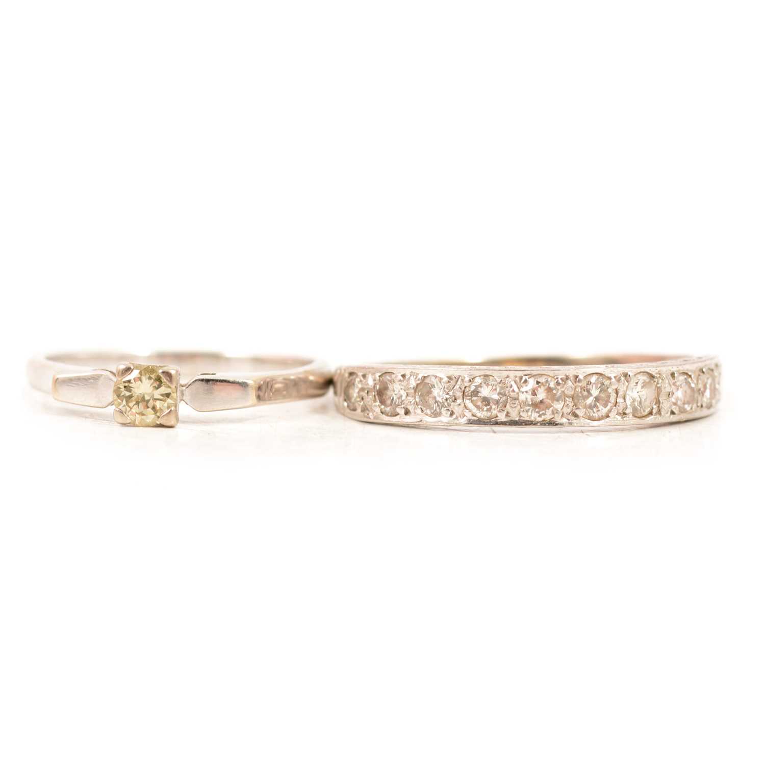 Lot 64 - A diamond solitaire ring and a diamond half eternity ring.