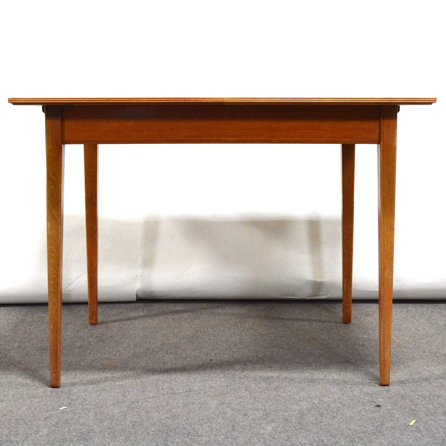 Lot 527 - Mid-century flame veneer extending dining table, possibly Gordon Russell