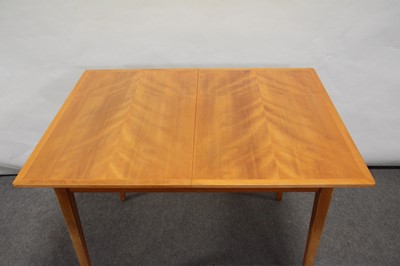 Lot 527 - Mid-century flame veneer extending dining table, possibly Gordon Russell