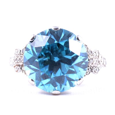 Lot 4 - A heat treated blue zircon and diamond dress ring.