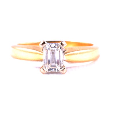 Lot 65 - A diamond emerald cut solitaire ring.