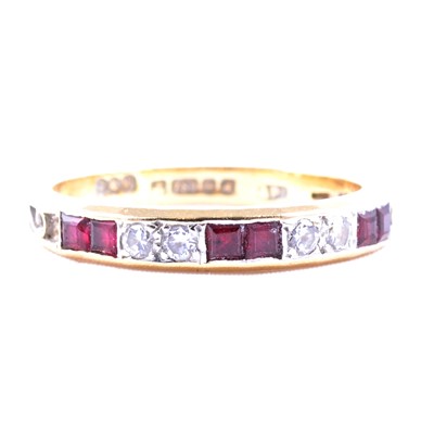 Lot 45 - A ruby and diamond half eternity ring.