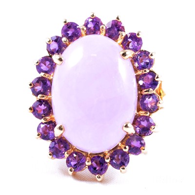 Lot 15 - A large oval amethyst cluster ring with cabochon centre.