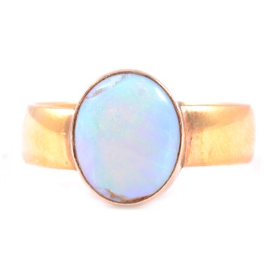 Lot 9 - A 22 carat yellow gold band set with an opal.