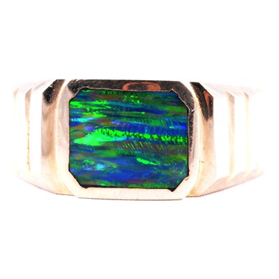 Lot 11 - A yellow metal signet style ring set with an opal coloured stone.