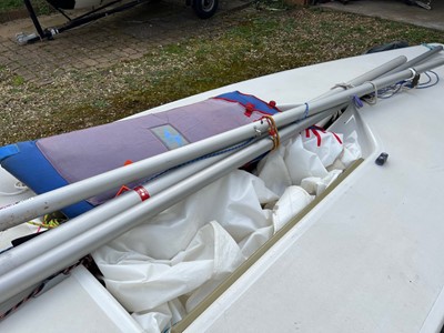 Lot 540 - 14ft Laser class dinghy sailboat, on trailer