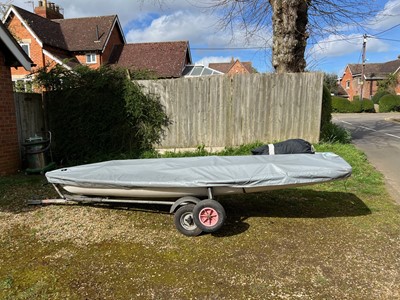 Lot 540 - 14ft Laser class dinghy sailboat, on trailer