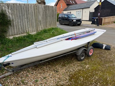 Lot 540 - 14ft Laser class dinghy sailboat, on trailer