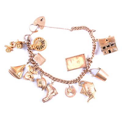 Lot 261 - A 9 carat gold charm bracelet with charms.