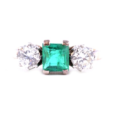 Lot 31 - A synthetic emerald and diamond three stone ring.