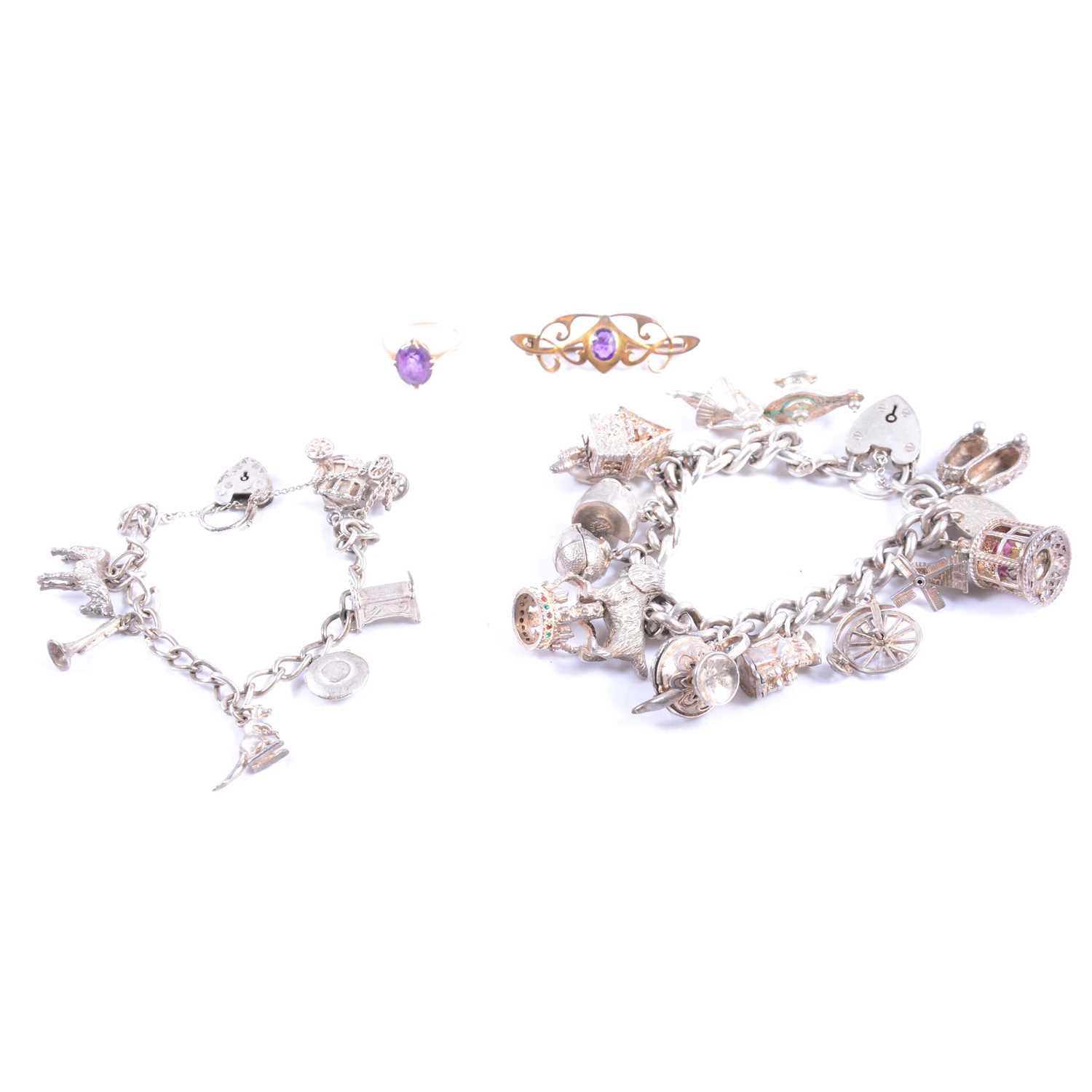 Lot 424 - Two silver charm bracelets with charms, an amethyst ring and bar brooch.