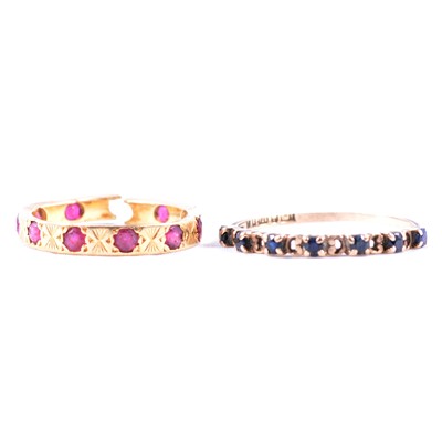 Lot 48 - A sapphire half eternity ring and a ruby eternity ring.