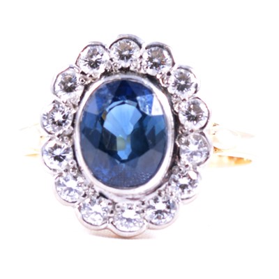 Lot 52 - A sapphire and diamond oval cluster ring.