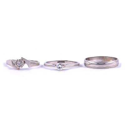 Lot 67 - A diamond solitaire ring, illusion set ring and wedding band, all platinum.