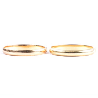 Lot 250 - Two 18 carat yellow gold modern half hinged bangles.