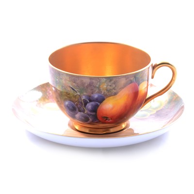 Lot 23 - Royal Worcester matched teacup and saucer, fruit painted