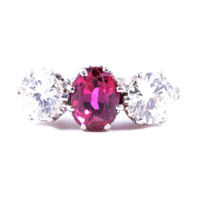Lot 36 - A ruby and diamond three stone ring.