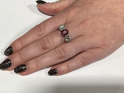Lot 36 - A ruby and diamond three stone ring.