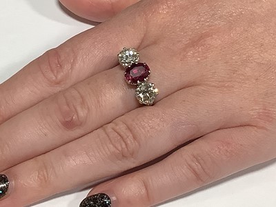 Lot 36 - A ruby and diamond three stone ring.