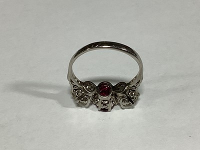 Lot 36 - A ruby and diamond three stone ring.