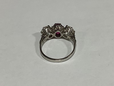 Lot 36 - A ruby and diamond three stone ring.