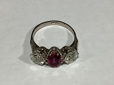 Lot 36 - A ruby and diamond three stone ring.