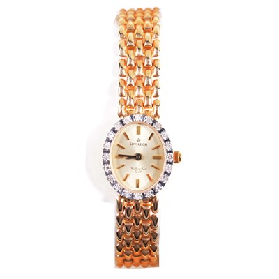 Lot 398 - Sovereign - a lady's 9 carat yellow gold bracelet wristwatch with diamond bezel.