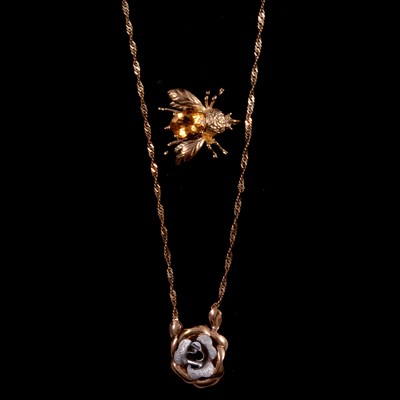 Lot 210 - A modern 9 carat yellow and white gold rose pendant and chain and a bee brooch.