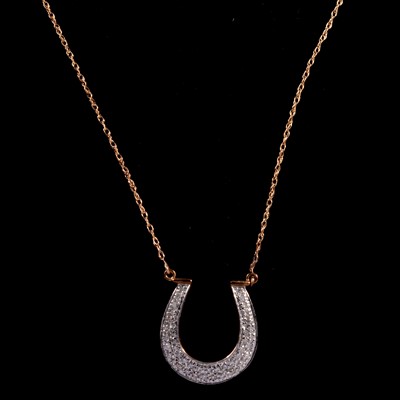 Lot 259 - A modern diamond horseshoe pendant and chain.