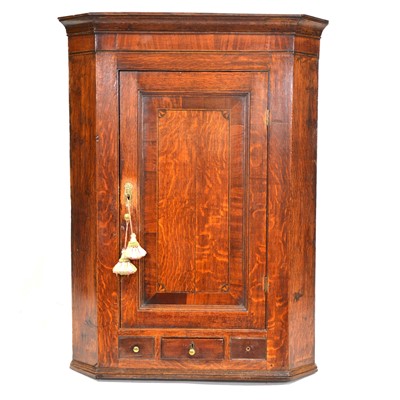 Lot 399 - George III oak hanging corner cupboard