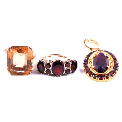 Lot 25 - A synthetic ruby and garnet pendant, a garnet ring and a citrine ring.