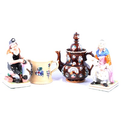 Lot 34 - Large Measham bargeware teapot, twin-handled tankard and two Old Age figures.