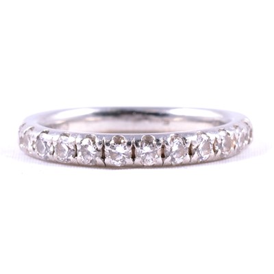 Lot 86 - A diamond half eternity ring.