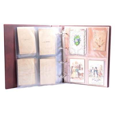 Lot 132 - Two albums of early to mid-20th century postcards, silks, social history.