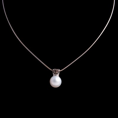 Lot 290 - A cultured pearl and diamond pendant on a chain.