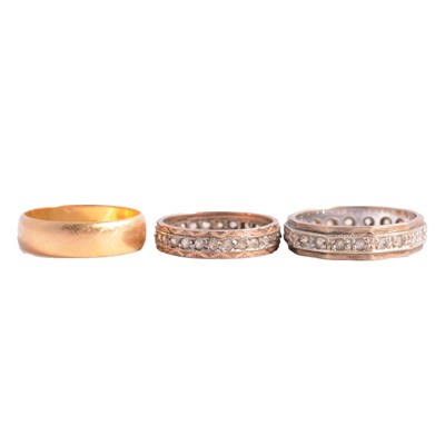 Lot 123 - A 22 carat yellow gold wedding band, two spinel eternity rings.