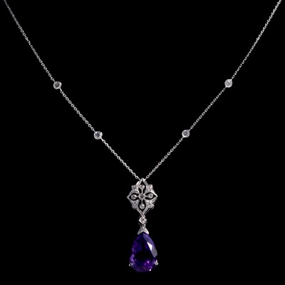 Lot 268 - An amethyst and diamond pendant on a diamond set chain.