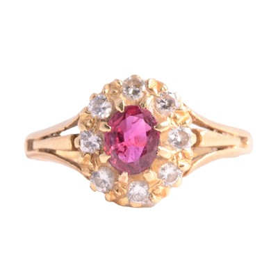 Lot 11 - A ruby and diamond cluster ring.