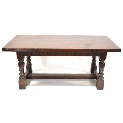 Lot 519 - Dark oak draw-leaf dining table