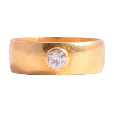 Lot 91 - A 22 carat yellow gold band set with a diamond.