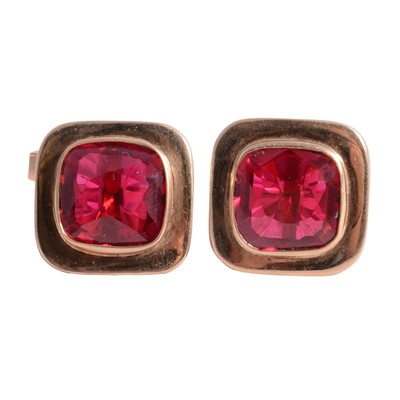 Lot 343 - A pair of yellow metal cufflinks set with crimson synthetic corundum.