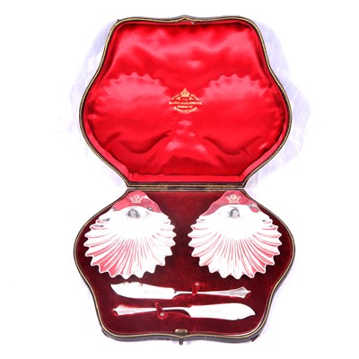 Lot 416 - Cased pair of silver butter dishes and butter knives, Goldsmiths & Silversmiths Company, London, 1899.